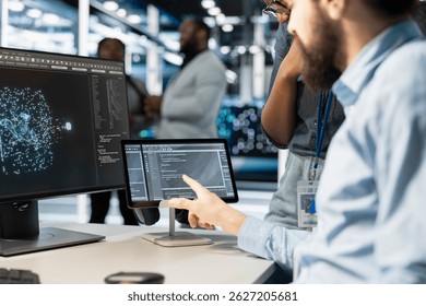 Close up of computer scientists in data center office integrating AI driven automation tools. Server farm employees cooperating, using artificial intelligence deep learning models - Powered by Shutterstock - Get 15% off with code: PIKWIZARD15