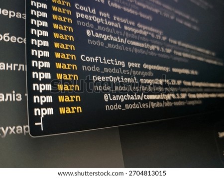 Close up of a computer screen displaying npm warn messages related to package dependencies during software development.