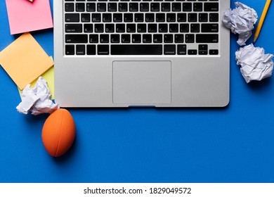 Close Up Of Computer, Stress Ball And Crumpled Paper With Blue Background, Stress Concept