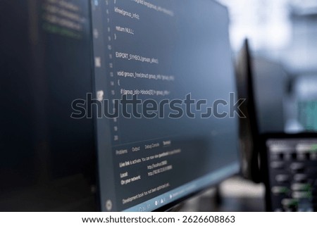 Close up of computers in empty data center facility managing rackmounts energy consumption. Binary script running on PC monitors used for automation and monitoring processes in server room