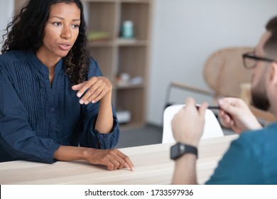 Close up confident african american woman applicant talking with hr manager at interview. Diverse young attractive female job seeker in negotiation with businessman employer at hire meeting.