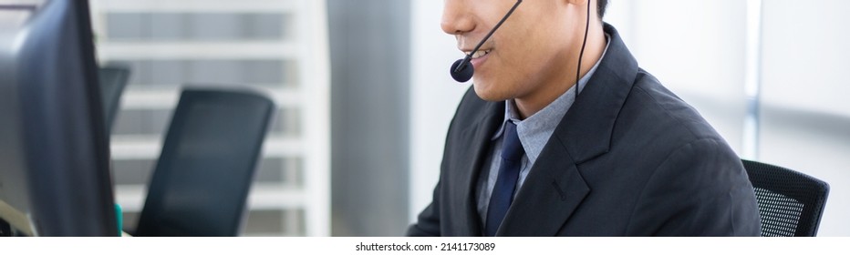 Close Up Of Confident Young Asian Men Call Center Staff Talking On Phone With Headset At Service Desk, Agent Man Give Business Advice To Client, Web Banner Of Customer Or Technician Support Concept