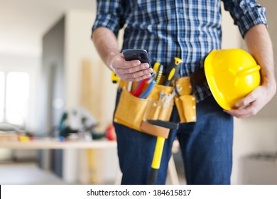 Close Up Of Construction Worker With Mobile Phone