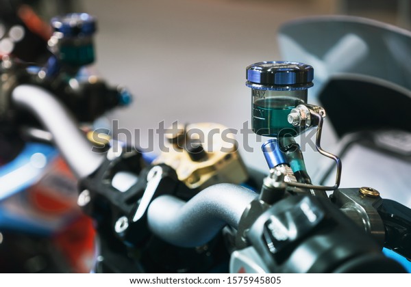 Close up of the container of\
motorcycle brake fluid, brake master cylinder\
reservoir.