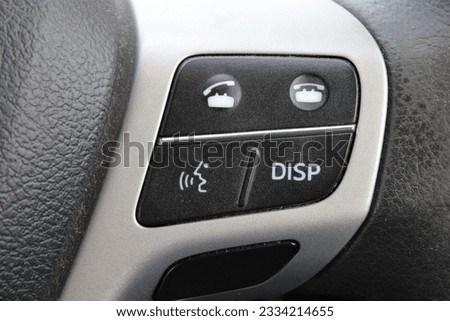 Close up of a control panel from a car steering wheel, buttons to pickup and end a call