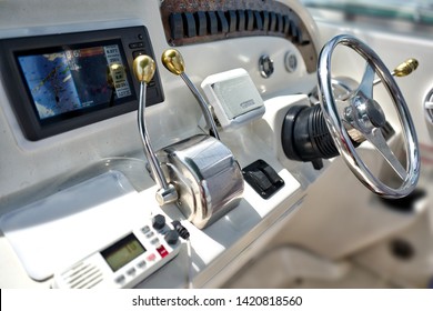 Close Up At Control Panel Navigation Instruments With Chromed Wheel On Fishing And Leisure Boat