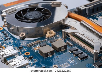 A close up of cooling fan for CPU computer motherboard PCB with chips on it 