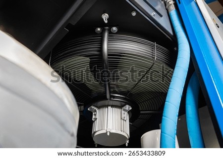 Close up of a cooling fan operating inside an industrial air compressor, highlighting essential components for ventilation and temperature regulation