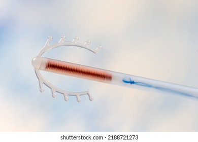 Close Up Of A Copper IUD Stored In A Plastic Tube Isolated On A Sky