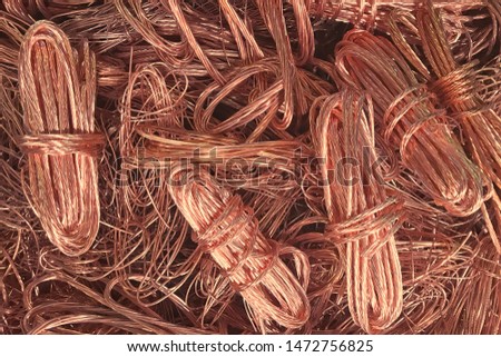 Close up copper wire scrap metal for recycliing or reproducing in the melting foundry. Bright berry copper raw material are reused in the industry. Non-ferrous scrap in the waste recycle manufacture.