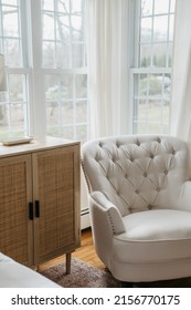 Close Up Of Corner Of Room With Night Stand And White Arm Chair With Window