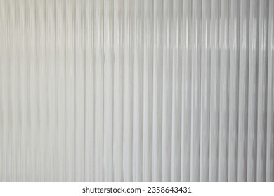 A Close up of corrugated glass texture with reflected,modern home decor,stylish home decor,Creative composition of living room,Wave glass vertical line pattern,Template.