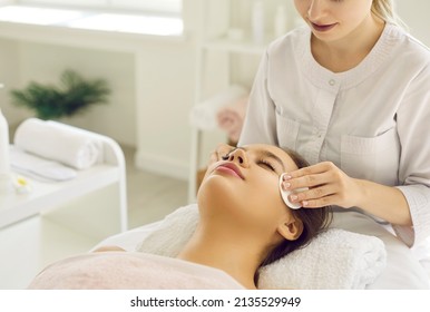 Close up of cosmetologist do beauty face procedures or treatment to woman client in aesthetic medicine clinic. Beautician doctor clean skin, make facial massage to patient. Cosmetology concept.