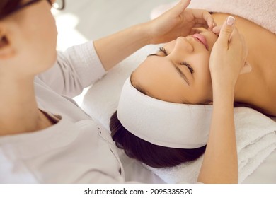 Close up of cosmetologist make rejuvenating face procedures for woman client in spa or saloon. Beautician do facial lifting massage to patient in aesthetic medicine clinic. Beauty, cosmetology. - Shutterstock ID 2095335520