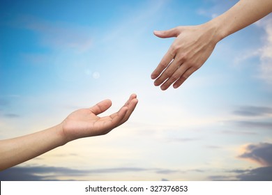 close up couple of helping praying hands on blur beautiful sunrise sky background to save for support people and social distance concept.
