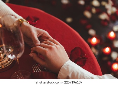 Close up of the couple holding hands on a romantic date with wine and candles. The concept for valentine's day or date. - Powered by Shutterstock