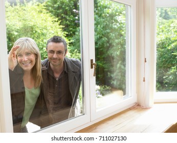 Close up of couple looking in window