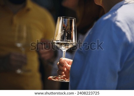 Close up of couple people drinking white sparkling wine outdoor. Alcoholic beverages tasting concept. Drinking on nature.