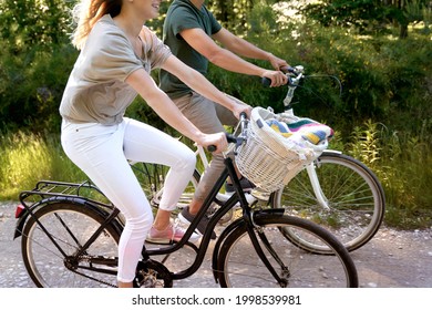 Close up of couple riding bikes in nature