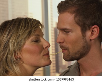 Close Up Of Couple Sharing Spaghetti Noodle