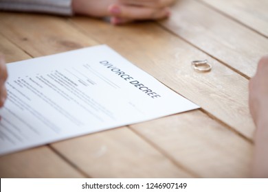 Close Up Of Couple Sign Divorce Decree With Marriage Rings Lying On Table, Family Separated Putting Signature On Legal Documents, Unhappy Spouse Finalize Relationships, Breaking Up At Lawyers Office