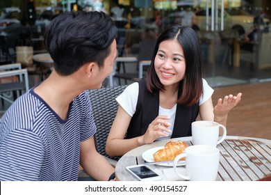 Close Up Couple Of Young Asian Man And Woman Talking Something Fun At Outside Coffee Shop.