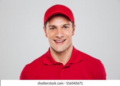 Close up courier. front portrait. smiling man. looking at camera. isolated gray background