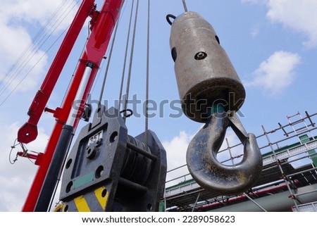 Close up crane hook for mobile crane in construction site and background is a scaffolding at chemical plant Industrial estate.                               