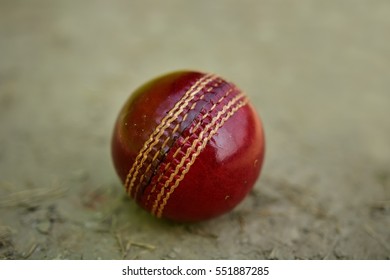 Close Up Cricket Ball On Pitch With Copy Space