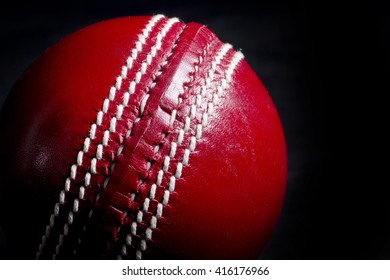 Close Up Of A Cricket Ball Seam With Black Background