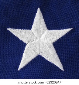 Close Of A Crisp White Embroidered Star On A US Veteran's Flag