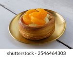 Close up of Croissant Cup Fla Orange on wooden table