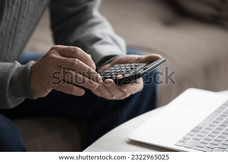 Close up crop view hands of unknown senior man count using calculator calculates expenses and incomes, manage household budget, pay taxes online in modern bank application, makes financial analysis Foto d'archivio © 