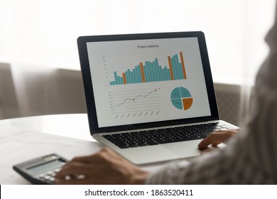 Close Up Crop View Of Woman Work Online On Computer Consider Financial Project Statistics With Graphs And Diagrams. Female Employee Count Expenses Expenditure On Laptop. Finance, Banking Concept.