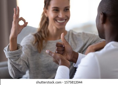 Close Up Cropped Image Smiling Millennial Deaf Woman Using Sign Language For Communication With African American Husband. Hearing Impaired Disabled Happy Family Couple Showing Gestures.