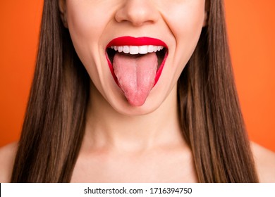 Close up cropped photo of carefree childish charming girl show tongue out isolated over vibrant color background