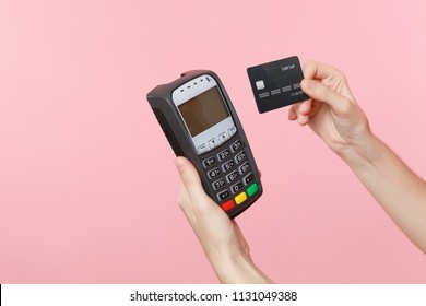 Close up cropped photo of female holding in hands wireless modern bank payment terminal to process and acquire credit card payments, black card isolated on pink background. Copy space for advertising