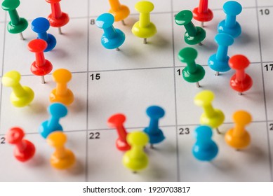 Close up cropped photo of many lot of colorful thumbtacks attached to the calendar with one blank empty space for weekend time