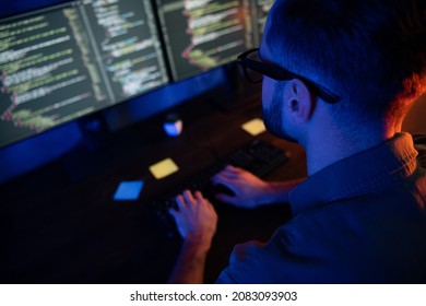 Close up cropped rear back portrait of young developer texting typing improving database late house dark room - Powered by Shutterstock