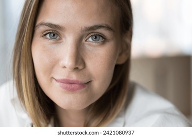 Close up cropped shot of beautiful young woman, smiling, staring at camera. Portrait of gorgeous millennial generation female with attractive appearance and perfect skin. Cosmetology, natural beauty