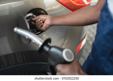 Close Up Cropped Shot Of A Gas Station Worker's Hands With Filling Gun, Ready To Refueling The Car With Gas Or Petrol At A Gas Station.