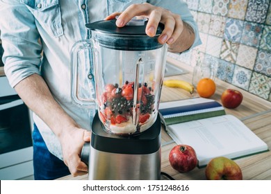 Close Up Cropped Shot Of Man Making Smoothie From Fresh Fruits And Berries In Professional Blender Or Food Processor.