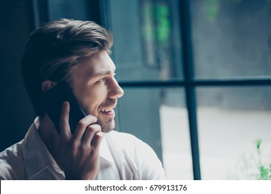 Close Up Cropped Side Profile Portrait Of A Successful Young Man, Having A Business Conversation,  At Work Station, Smiling, Looking In The Window