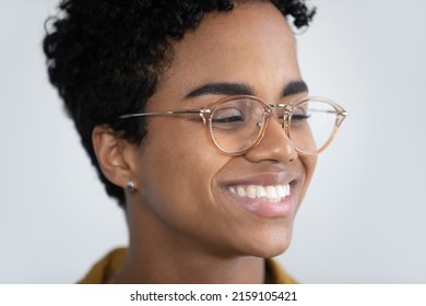 Close Up Cropped View Face Of Attractive African Woman In Glasses Having Wide Toothy Smile Look Aside Pose On White Studio Background. Eyewear, Lenses Store Ad, Happy Young 20s Female Portrait Concept