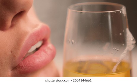 Close up cropped view unknown unrecognizable sexy sensual Caucasian relaxed drunk woman female smooth lips girl lady in spa home holding glass of champagne alcohol addiction drinking beverage drink
