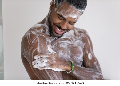 Close Up Cropped View Young African Man Lather His Muscular Build Body With Hydrating Shower Gel, Use Natural Quality Fragrant Bodycare Wash Product. Self Hygiene, Skincare, Morning Routine Concept