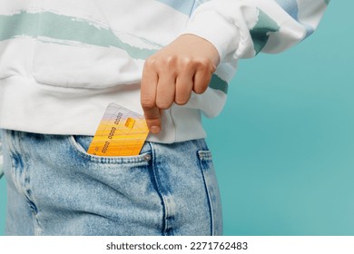 Close up cropped woman wears striped hoody denim pants hold in hand put into pocket mock up of credit bank cardisolated on plain pastel light blue cyan background studio portrait. Lifestyle concept - Powered by Shutterstock