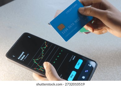 close up  of crypto trader analyzing live crypto and stock charts on smartphone with trading platform app, displayed on  phone screen. 