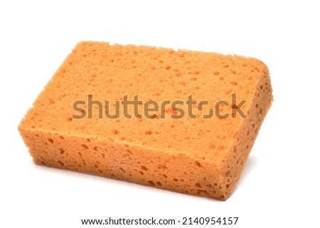 Close up of cuboid raw orange sponge for cleaning tile grouting and wiping on white background