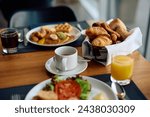 Close up of cup of coffee and buffet breakfast in hotel restaurant.